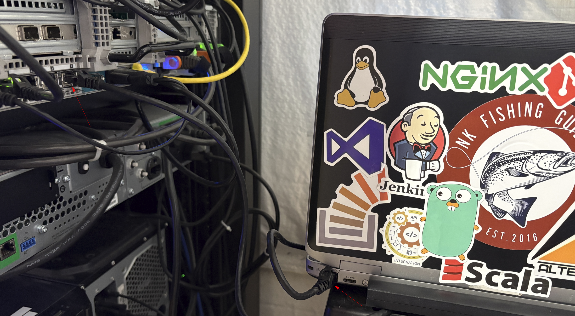 Ethernet cable running from the mirror NIC on the Proxmox server to a utility laptop, with arrows marking both ends.